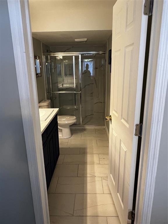9070 Lime Bay Boulevard, Unit 209 Tamarac, FL 33321 - Photo 20 of 27 a bathroom with a toilet mirror and shower