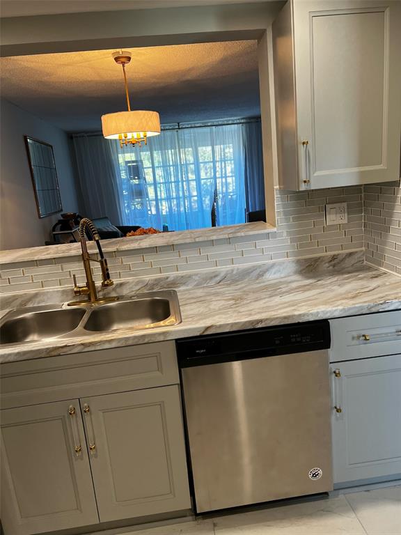 9070 Lime Bay Boulevard, Unit 209 Tamarac, FL 33321 - Photo 24 of 27 a kitchen with a sink and a window