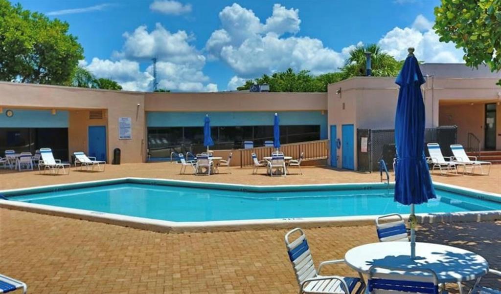 9070 Lime Bay Boulevard, Unit 209 Tamarac, FL 33321 - Photo 26 of 27 a view of a house with swimming pool and sitting area