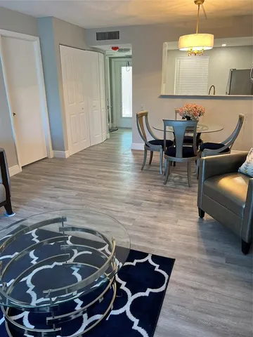 a room with wooden floor and furniture