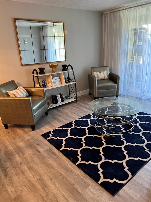 9070 Lime Bay Boulevard, Unit 209 Tamarac, FL 33321 - Photo 6 of 27 a bedroom with a bed and a couch