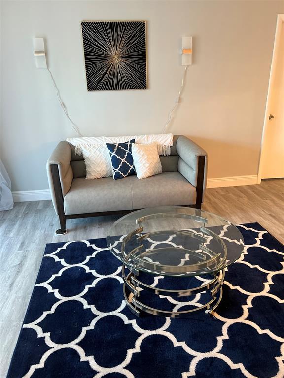 9070 Lime Bay Boulevard, Unit 209 Tamarac, FL 33321 - Photo 7 of 27 a living room with a black white checkered floor with a black white checkered floor