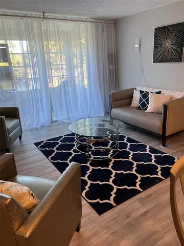 a living room with furniture and a rug