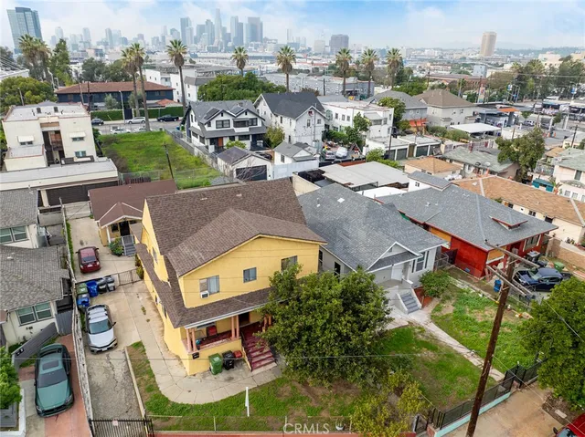 an aerial view of a house with a swimming pool outdoor seating and yard
