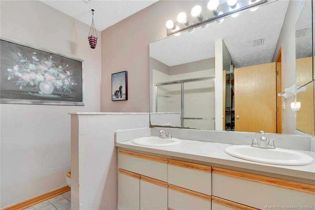 952 Southwest Commonwealth Road Port St. Lucie, FL 34953 - Photo 17 of 33 a bathroom with a sink and a mirror