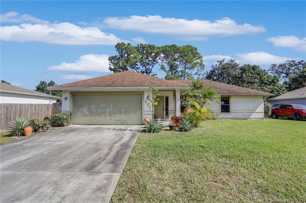 952 Southwest Commonwealth Road Port St. Lucie, FL 34953 - Photo 31 of 33 front view of a house with a yard