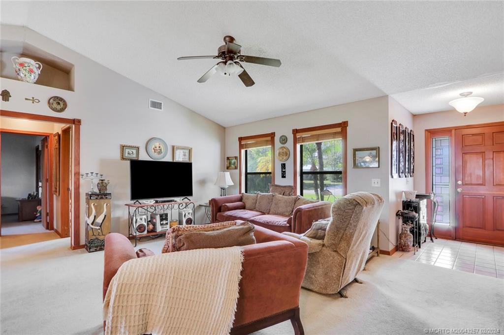 952 Southwest Commonwealth Road Port St. Lucie, FL 34953 - Photo 6 of 33 a living room with furniture and a flat screen tv