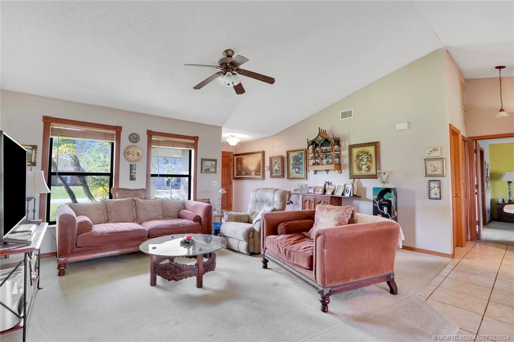 952 Southwest Commonwealth Road Port St. Lucie, FL 34953 - Photo 7 of 33 a living room with furniture and a large window