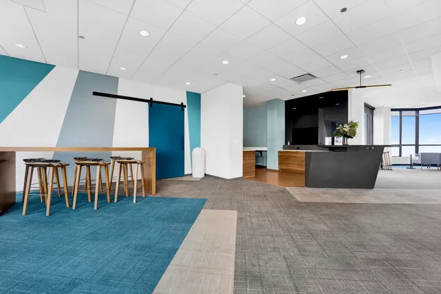 a view of kitchen with furniture and a refrigerator
