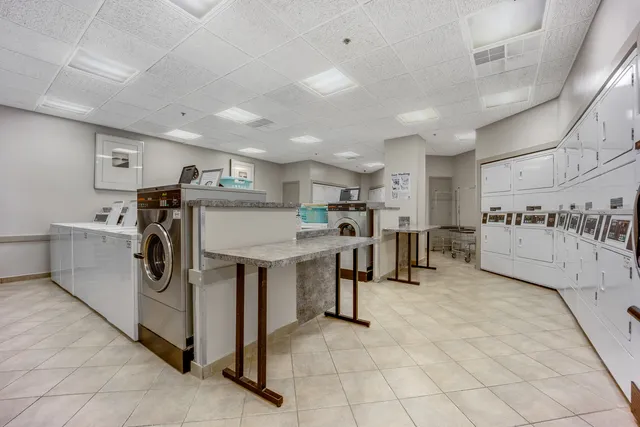 a kitchen with stainless steel appliances granite countertop a sink and a refrigerator