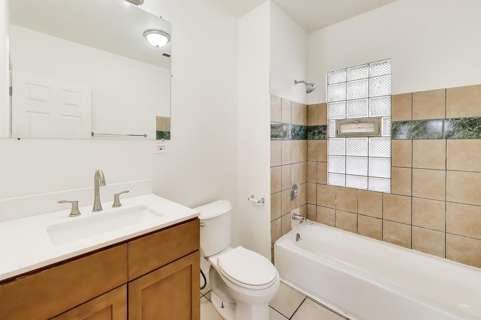 6853 South Perry Avenue Chicago, IL 60621 - Photo 22 of 28 a bathroom with a sink a toilet and shower