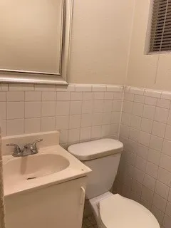 a white toilet sitting next to a bathroom sink
