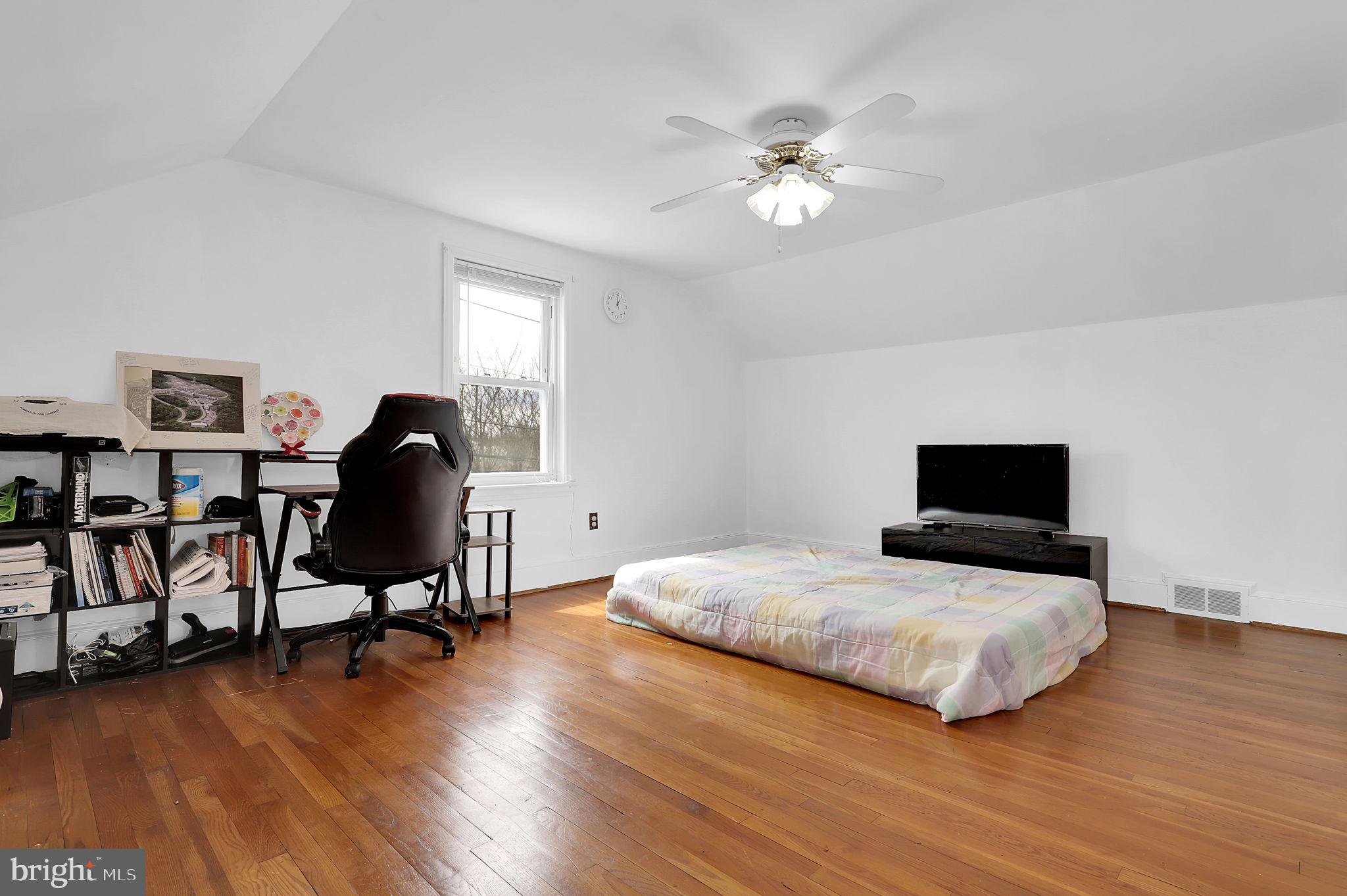 404 Biggs Avenue Frederick, MD 21702 - Photo 15 of 47 a bedroom with a bed and a chandelier