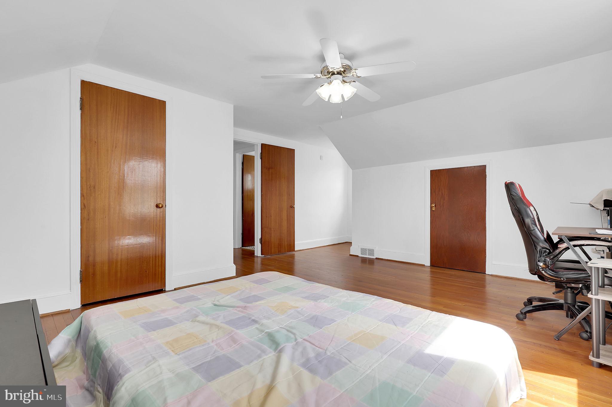 404 Biggs Avenue Frederick, MD 21702 - Photo 16 of 47 a bedroom with a bed and a chandelier