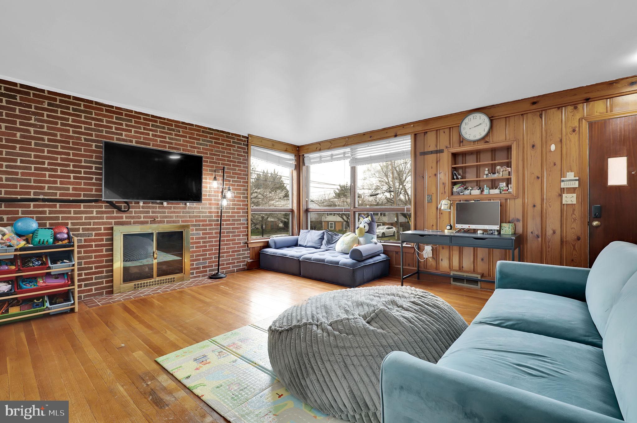 404 Biggs Avenue Frederick, MD 21702 - Photo 2 of 47 a living room with furniture a fireplace and a flat screen tv