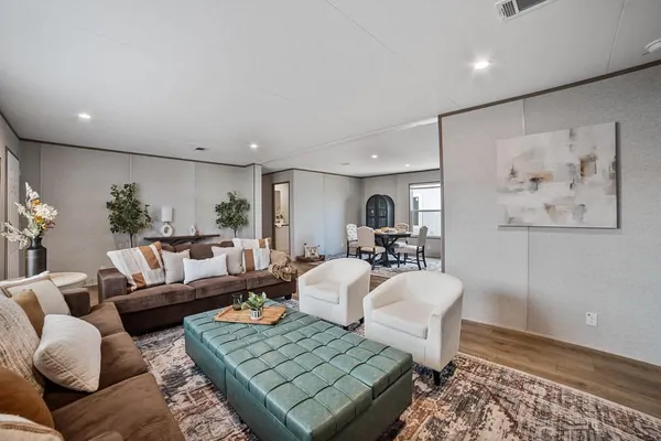 a living room with furniture and wooden floor