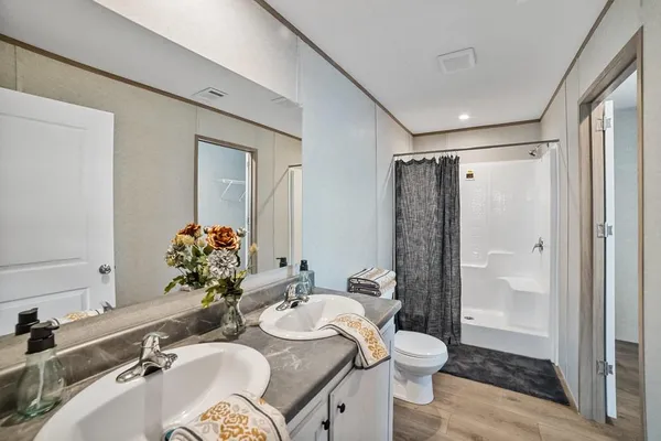 a bathroom with a sink toilet and shower
