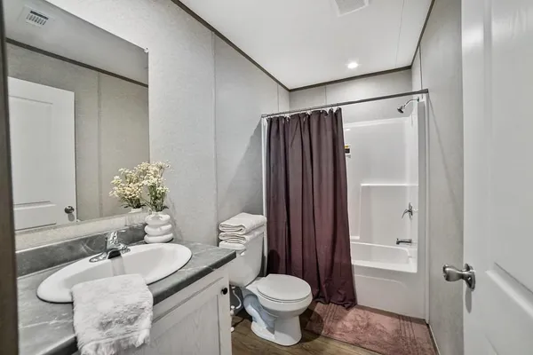 a bathroom with a toilet a sink and bathtub