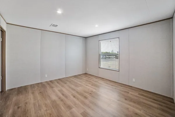 a view of a workspace with furniture and wooden floor