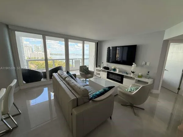 a living room with furniture and a flat screen tv