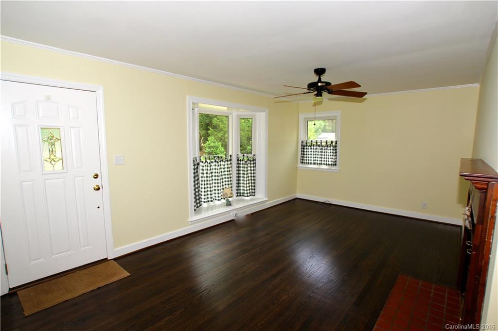 825 Manhasset Road Charlotte, NC 28209 - Photo 2 of 20 a view of an empty room with wooden floor and a window