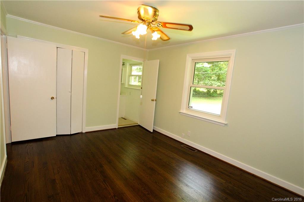 825 Manhasset Road Charlotte, NC 28209 - Photo 15 of 20 a view of an empty room with window and wooden floor