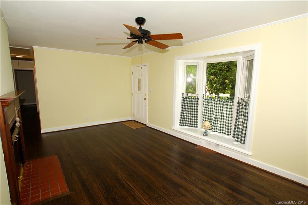 825 Manhasset Road Charlotte, NC 28209 - Photo 3 of 20 a view of empty room with wooden floor and fan