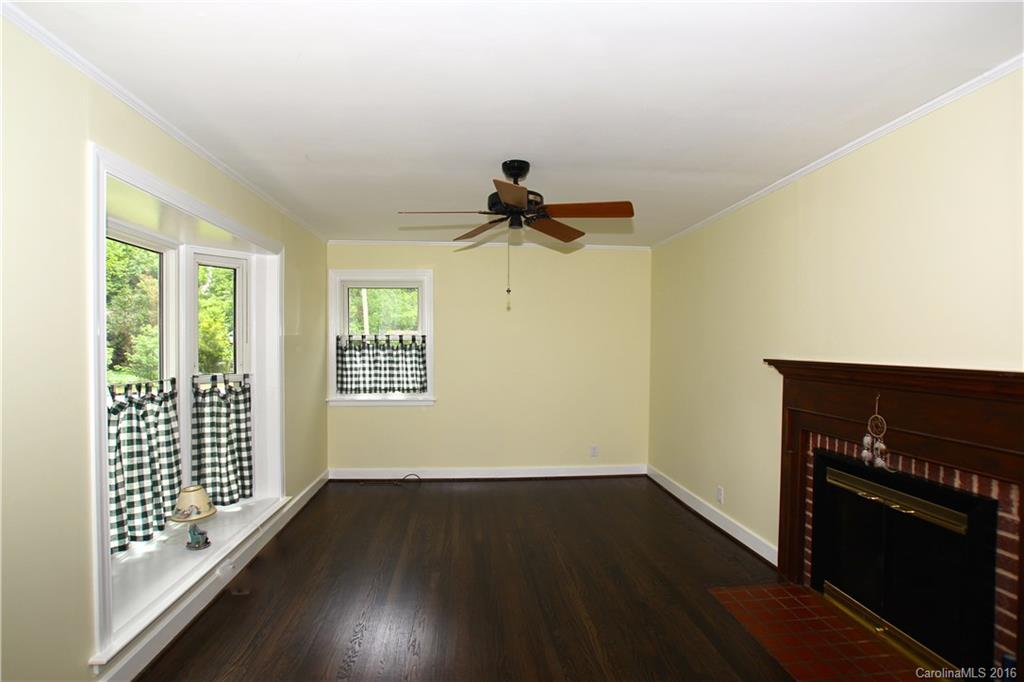 825 Manhasset Road Charlotte, NC 28209 - Photo 4 of 20 a view of empty room with wooden floor and fan