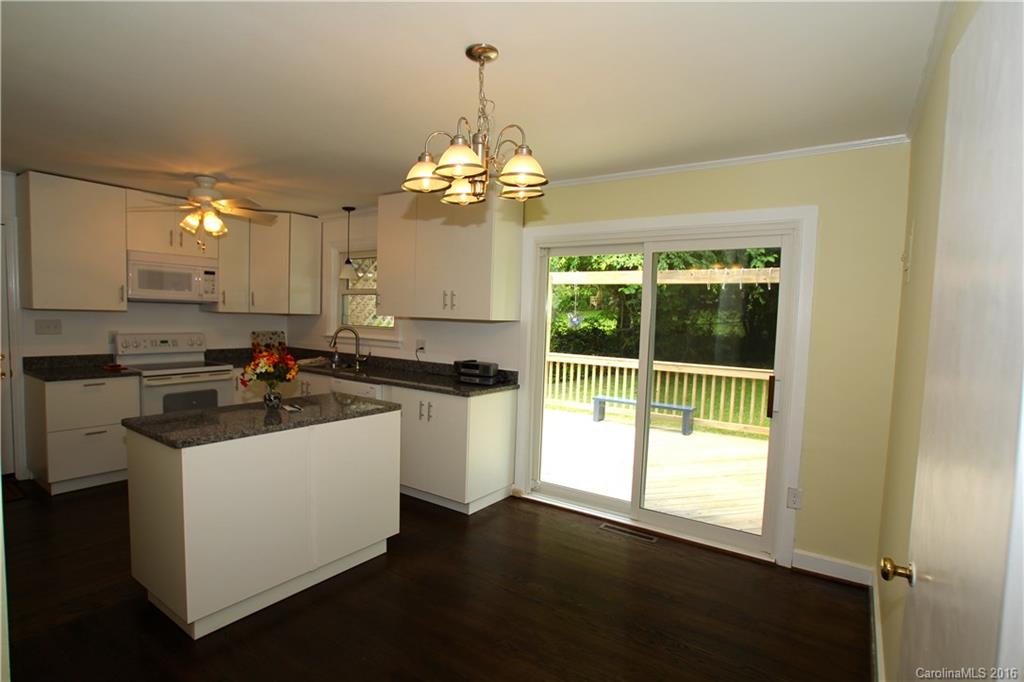825 Manhasset Road Charlotte, NC 28209 - Photo 5 of 20 a kitchen with a sink stove and cabinets