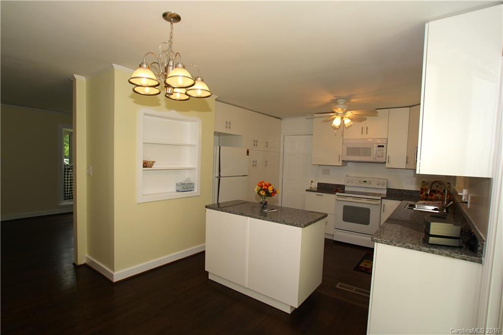 825 Manhasset Road Charlotte, NC 28209 - Photo 6 of 20 a kitchen that has a lot of cabinets and a stainless steel appliances