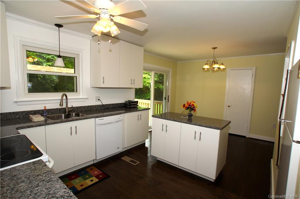 825 Manhasset Road Charlotte, NC 28209 - Photo 8 of 20 a kitchen with a sink and white cabinets