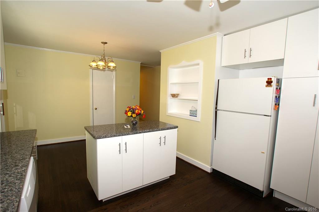 825 Manhasset Road Charlotte, NC 28209 - Photo 9 of 20 a white refrigerator freezer sitting inside of a kitchen