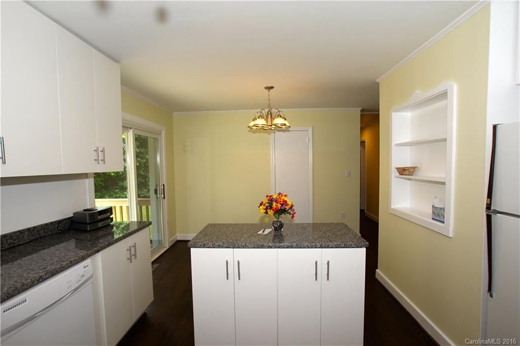 825 Manhasset Road Charlotte, NC 28209 - Photo 10 of 20 a kitchen with a refrigerator and a stove
