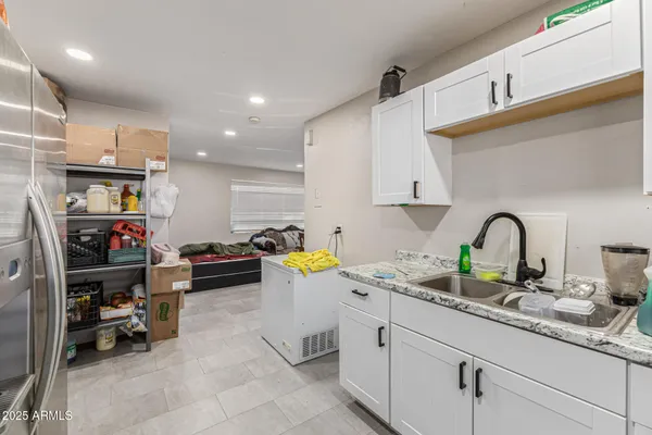 a kitchen with sink cabinets and appliances