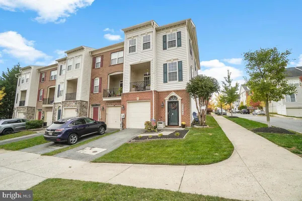 a front view of a residential apartment building with a yard