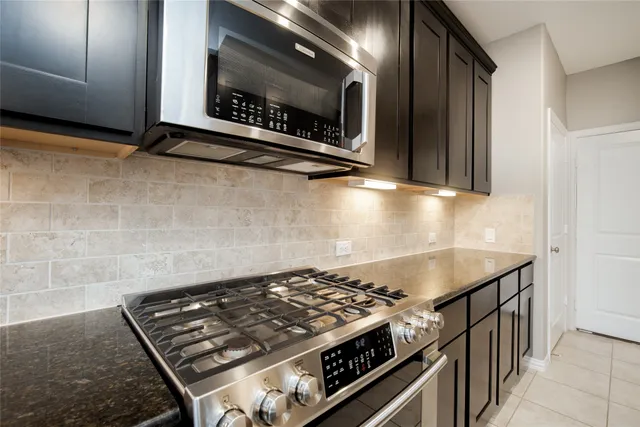 a stove top oven sitting inside of a kitchen