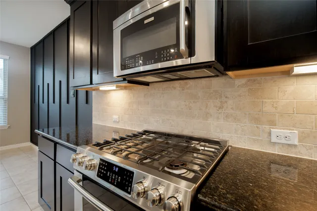 a stove top oven sitting inside of a kitchen