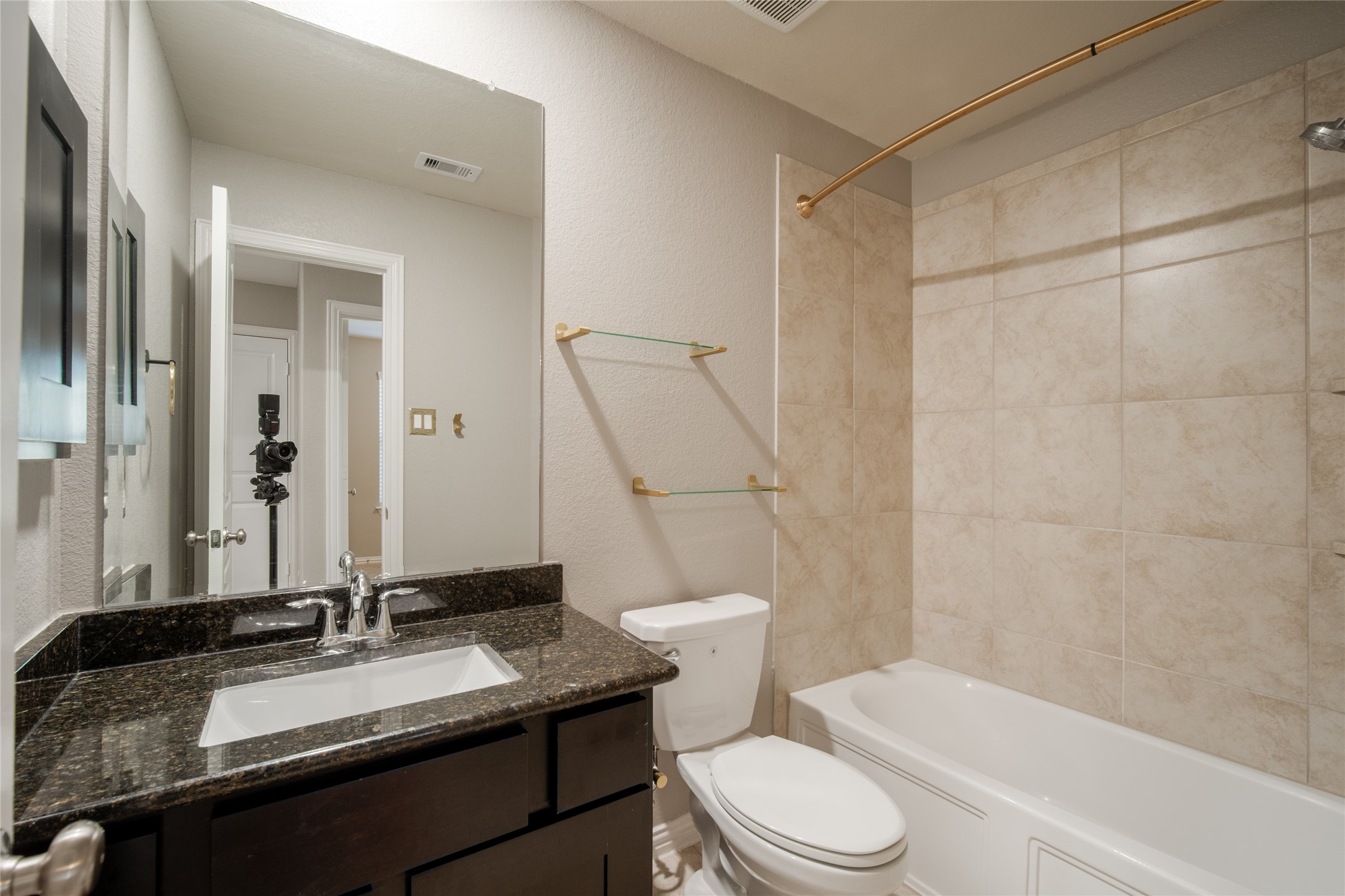 1826 Ryon Falls Drive Richmond, TX 77469 - Photo 21 of 35 a bathroom with a granite countertop sink toilet mirror and shower