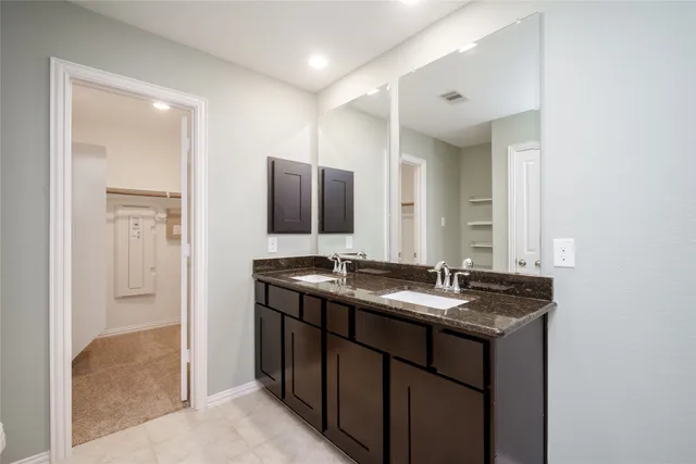a bathroom with a granite countertop sink mirror and shower