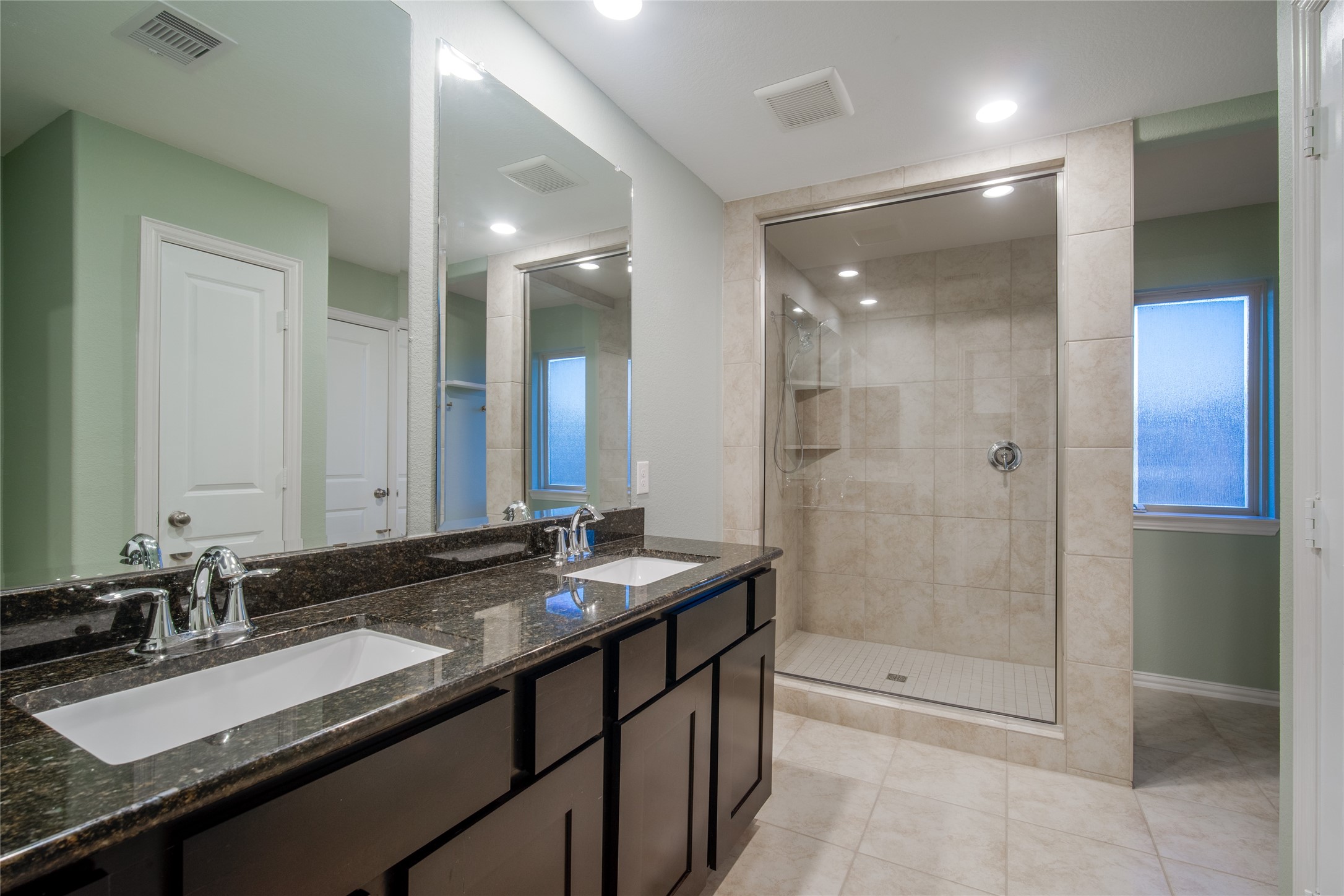 1826 Ryon Falls Drive Richmond, TX 77469 - Photo 29 of 35 a bathroom with a granite countertop sink mirror and shower