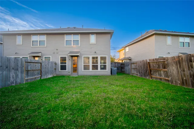 a view of a house with a yard and porch