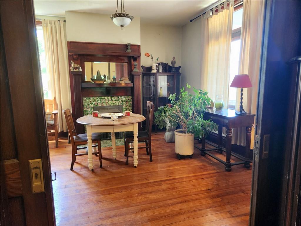 Through these pocket doors are set up like a diningroom. The hardwood floors and the fireplace set the atmosphere.