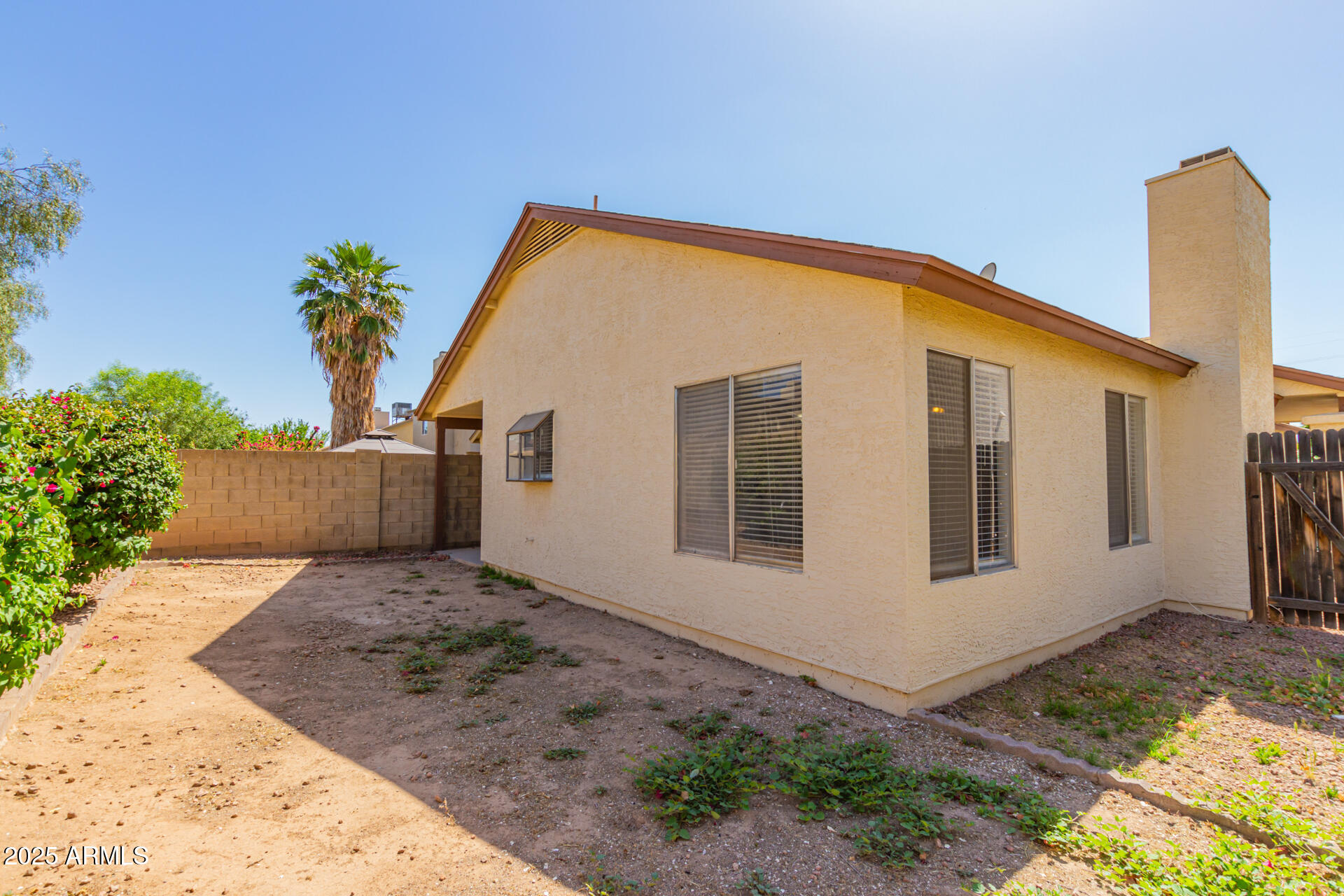 10015 North 66th Drive Glendale, AZ 85302 - Photo 18 of 20 a view of backyard with plants and wooden fence