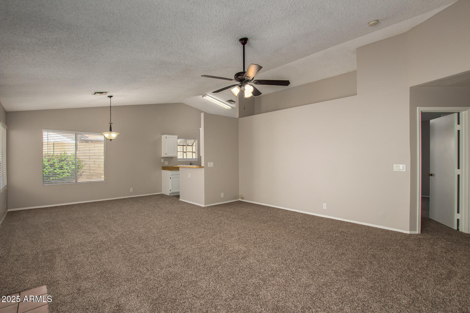 10015 North 66th Drive Glendale, AZ 85302 - Photo 2 of 20 a view of an empty room with a window