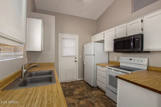 a view of empty room with fireplace and fan