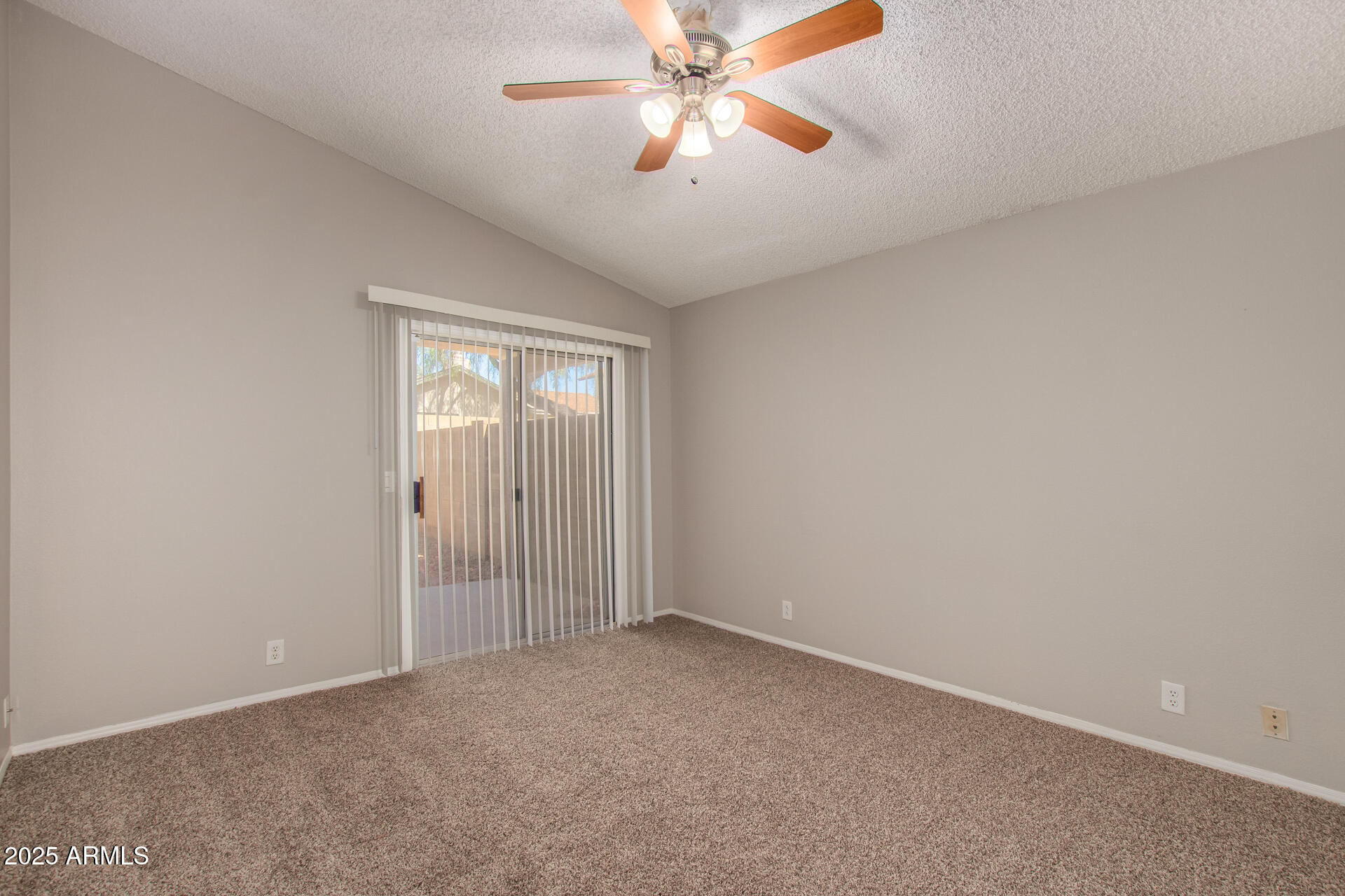 10015 North 66th Drive Glendale, AZ 85302 - Photo 8 of 20 an empty room with chandelier fan