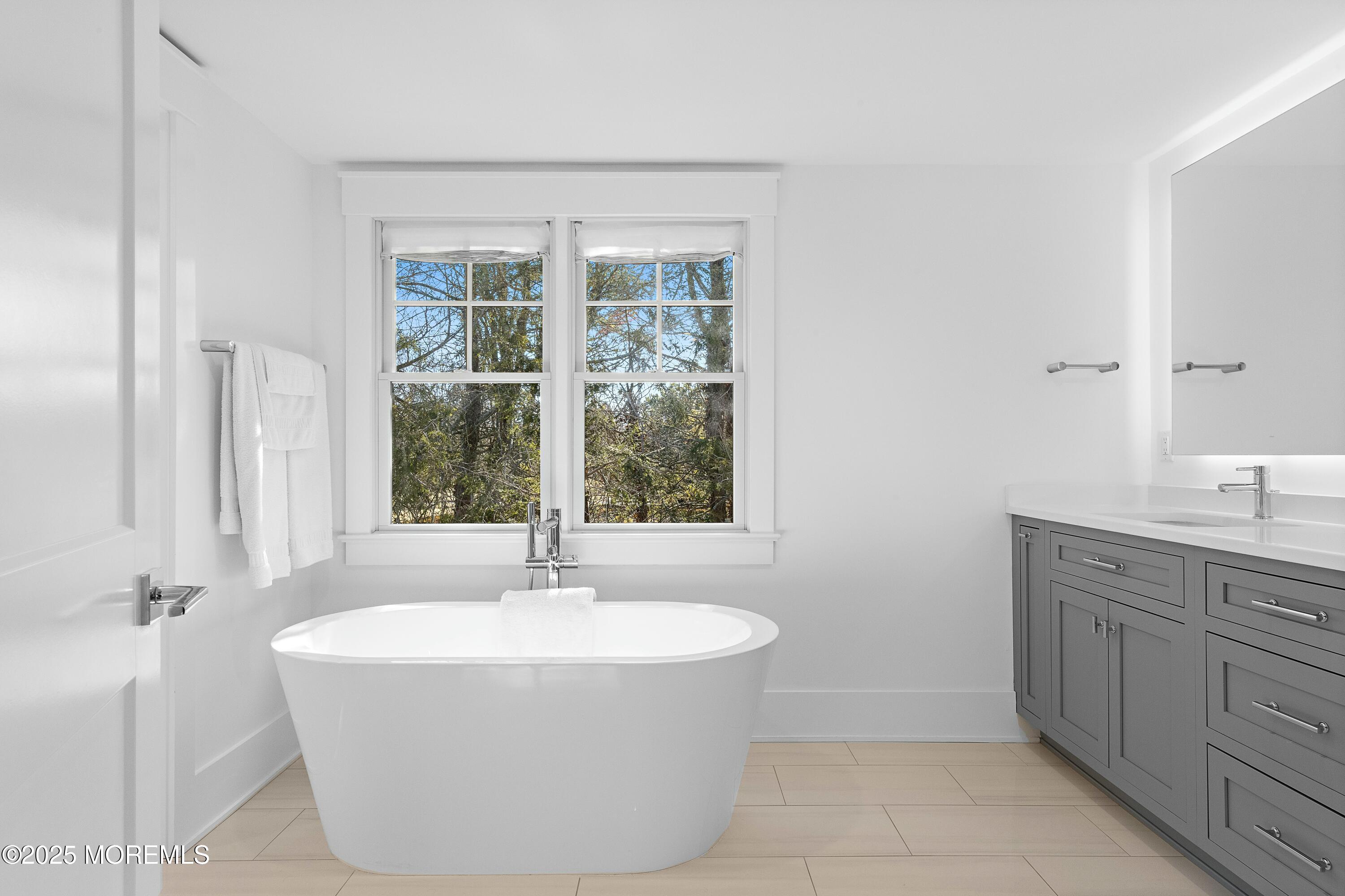 615 Harding Road Little Silver, NJ 07739 - Photo 40 of 94 a bath tub sitting in a bathroom next to a window