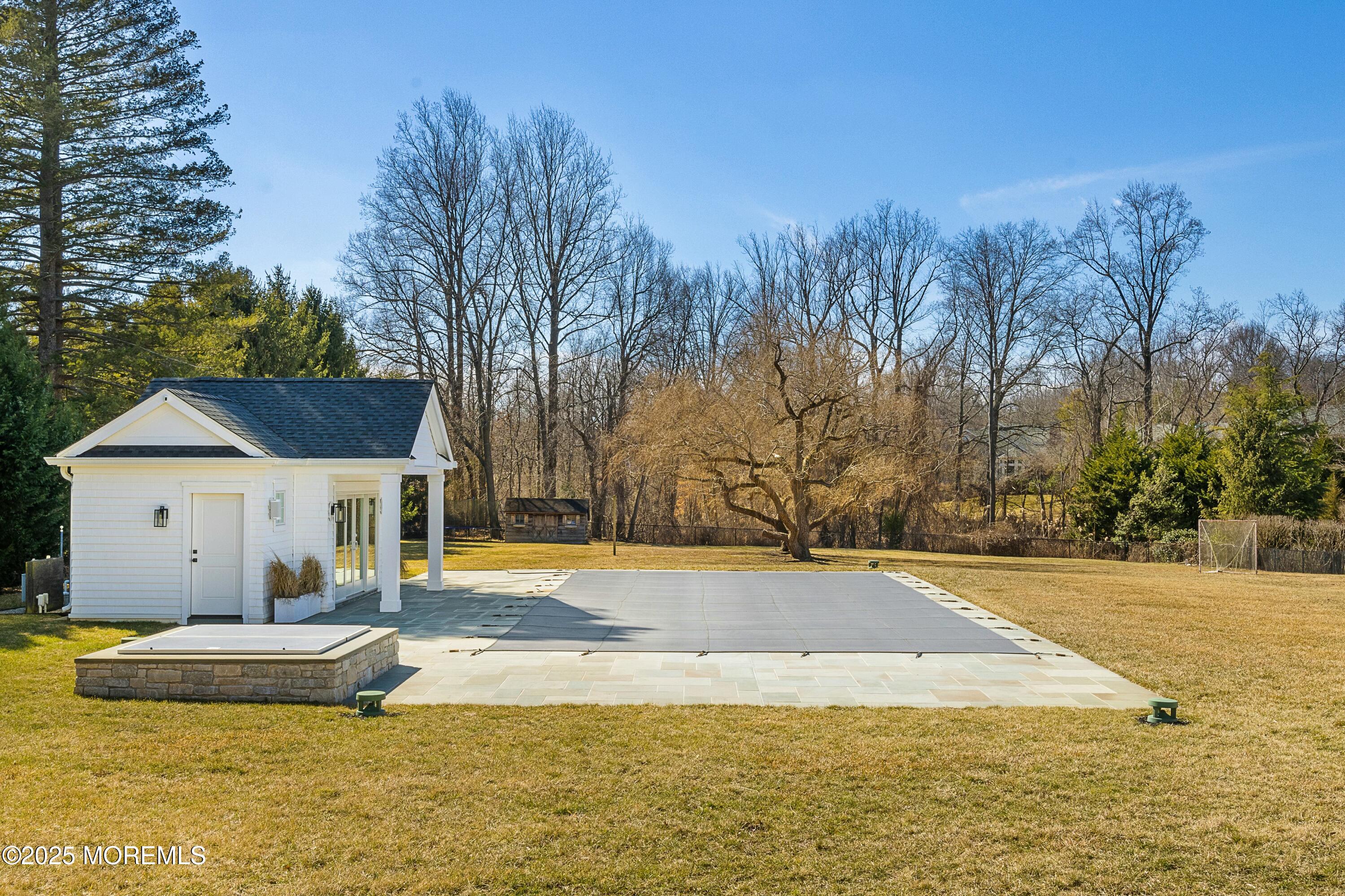 615 Harding Road Little Silver, NJ 07739 - Photo 67 of 94 a view of a house with pool and trees in the background