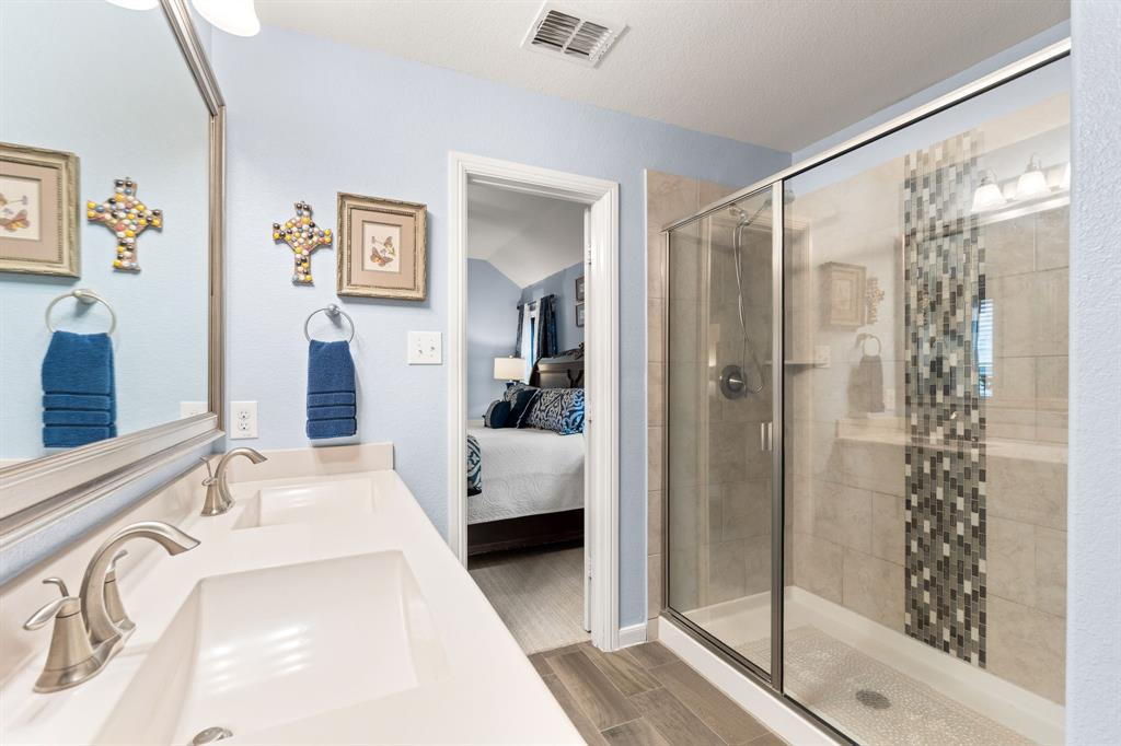 300 Copper Switch Drive Anna, TX 75409 - Photo 14 of 26 Primary bathroom with decorative tiled walk in shower
