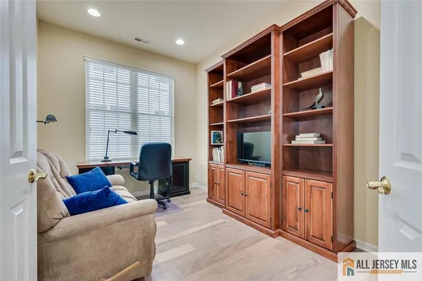 a view of a livingroom with workspace and a couch